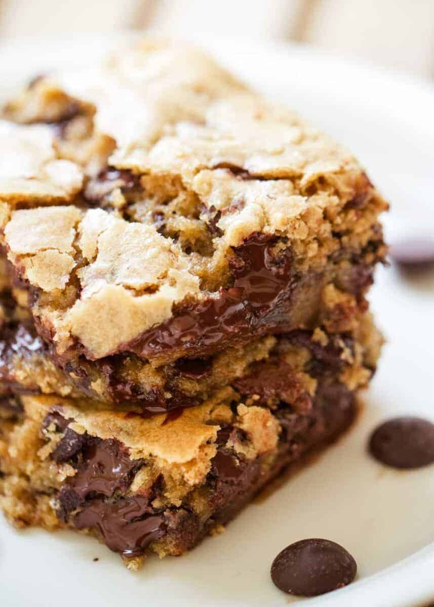 These congo bars are a soft and chewy chocolate chip cookie bars made using one bowl and a sheet pan. They are so easy to make and are perfect for a crowd! Congo bars stacked on top of each other.