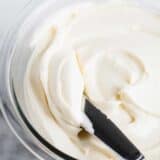 spreading cream cheese frosting with knife