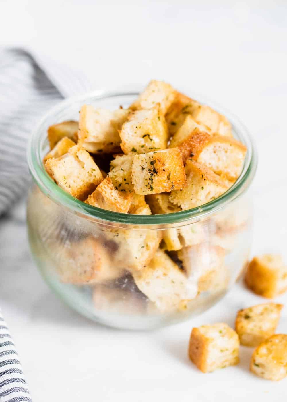 Homemade croutons in a glass jar.