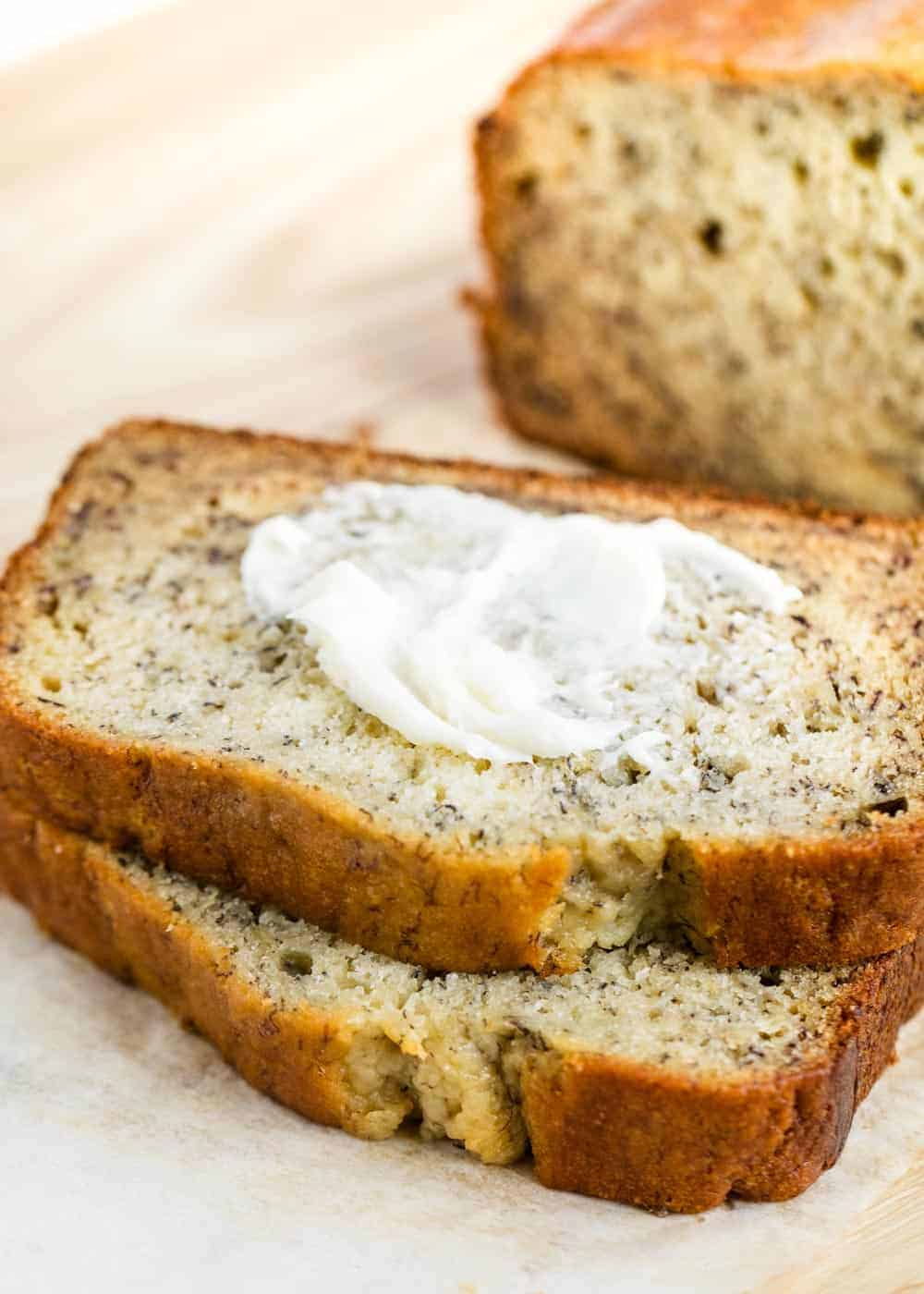 Piece of banana bread with butter on top.