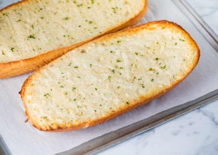 french bread garlic bread on baking sheet 