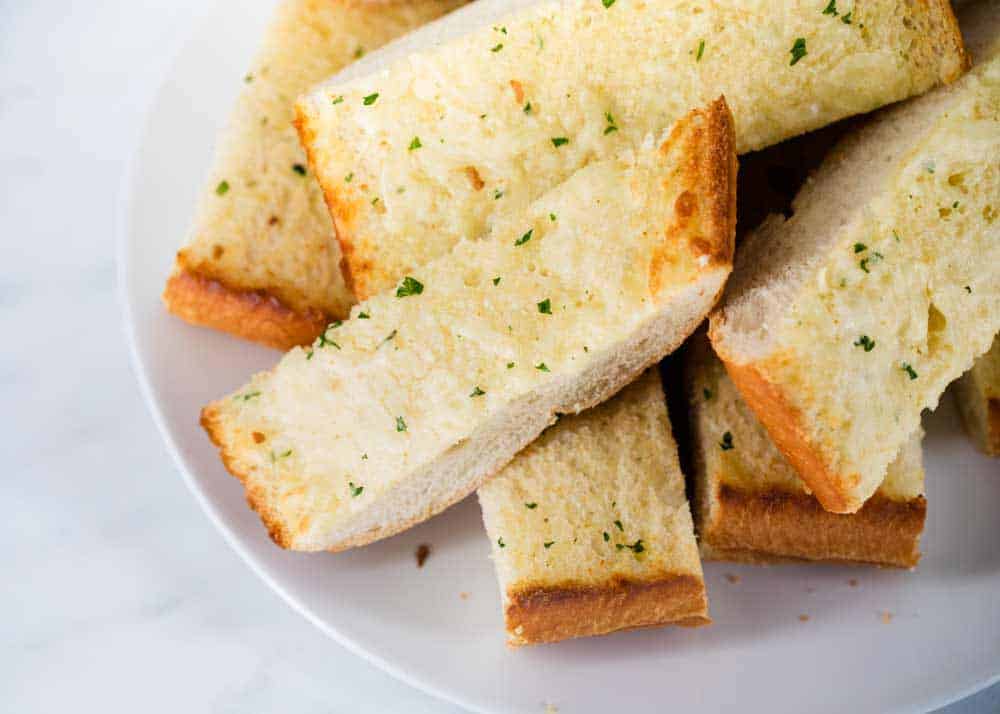 Sliced garlic bread on plate.