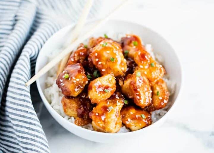 general tso chicken in bowl with chopsticks