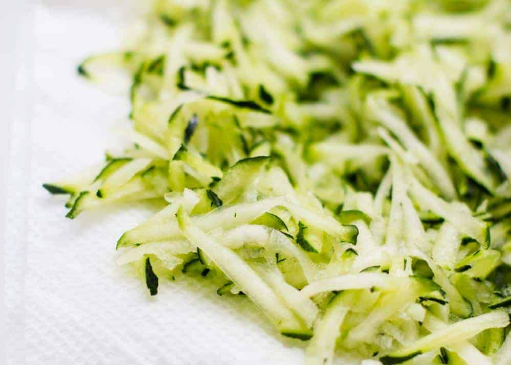 Shredded zucchini on a paper towel.