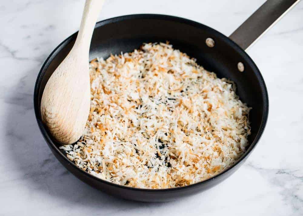 Toasting coconut in a skillet.