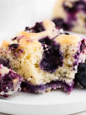 Bite taken from blueberry buttermilk cake.