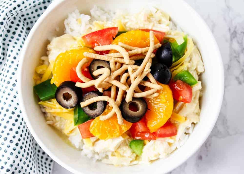 These Hawaiian haystacks are a family favorite dinner that's easy, inexpensive and completely customizable. Made in the crockpot and perfect for busy weeknights. Hawaiian haystacks in a white bowl.