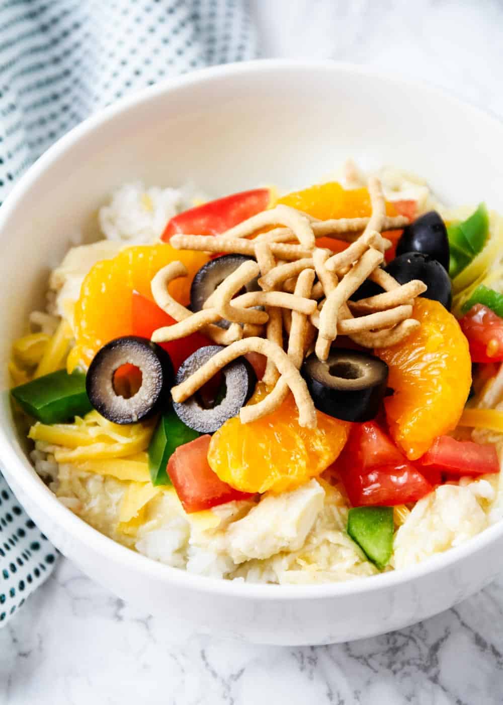 Hawaiian haystack in a white bowl with toppings.