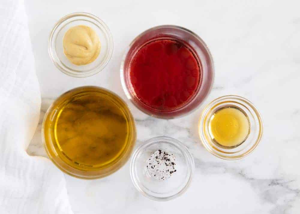 Ingredients for vinaigrette in bowls on counter.