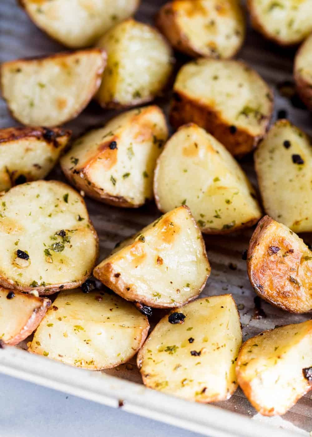 Oven roasted red potatoes in pan.