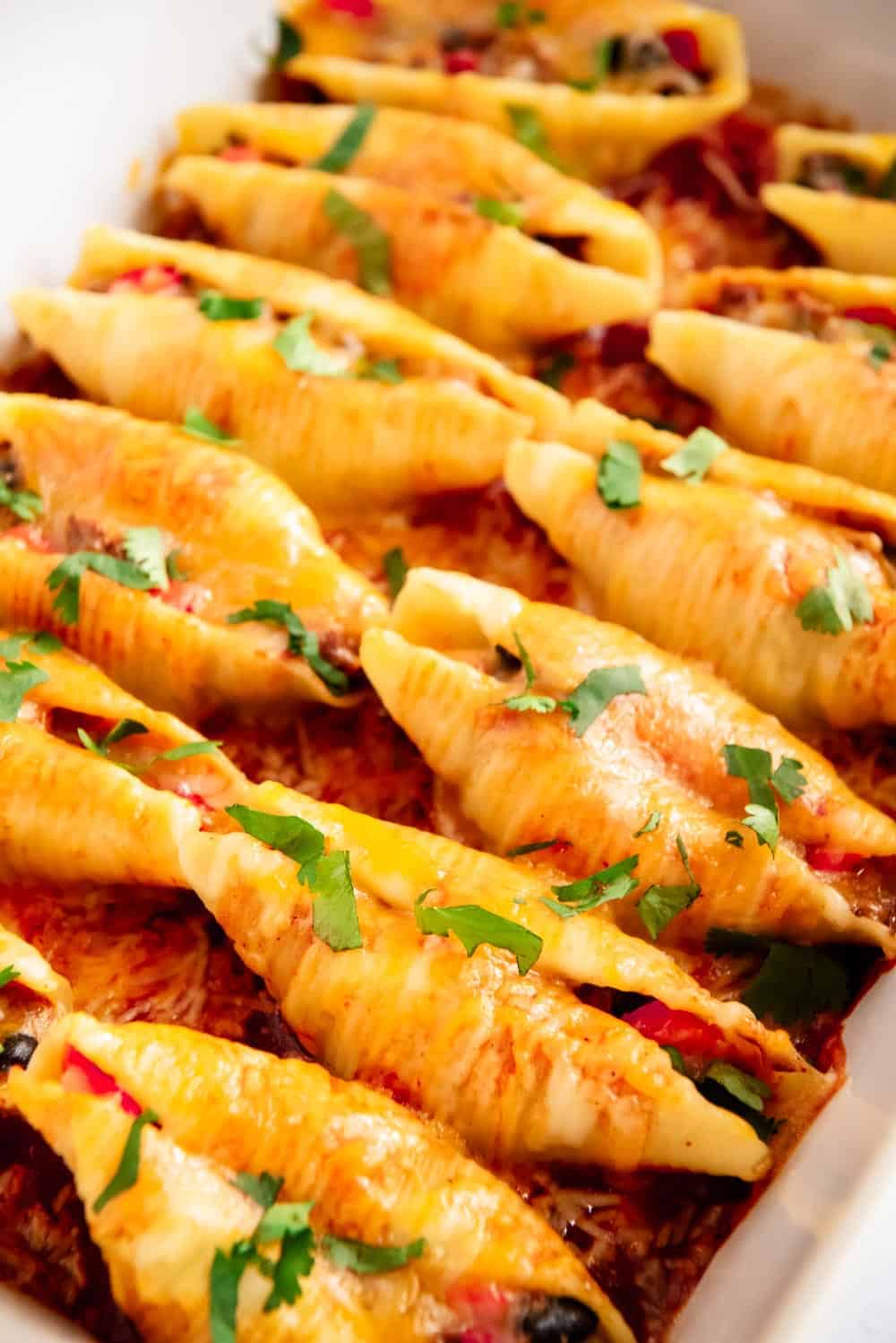 Taco stuffed shells in baking dish.