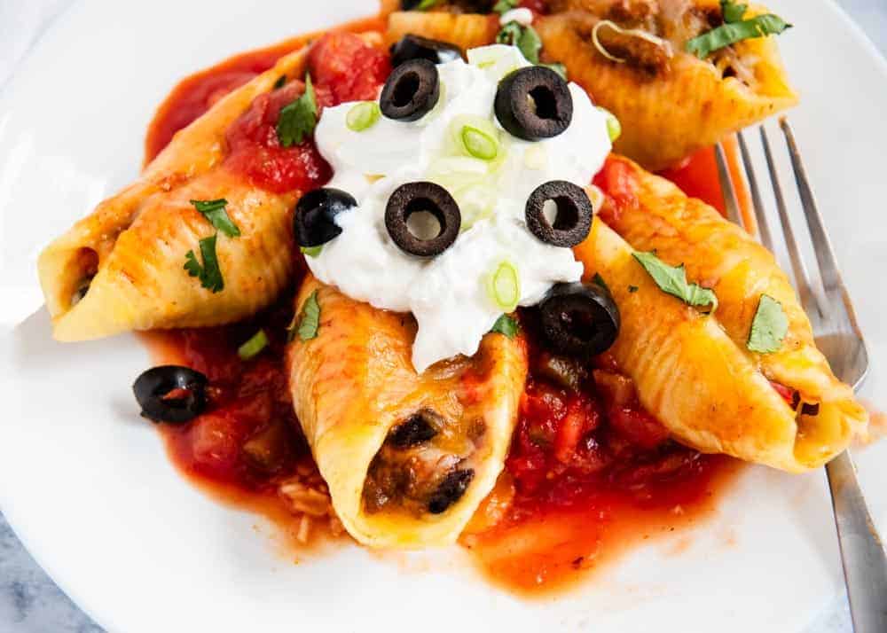 Taco stuffed shells on plate.