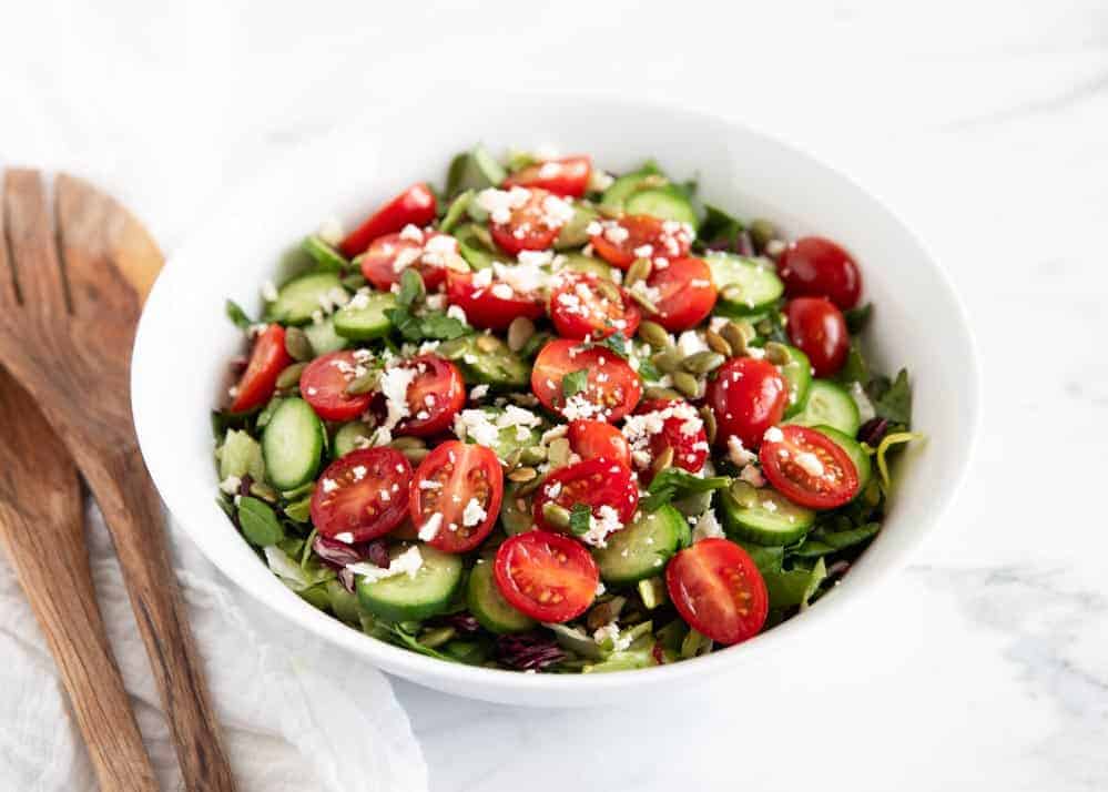 Chopped salad in white bowl.