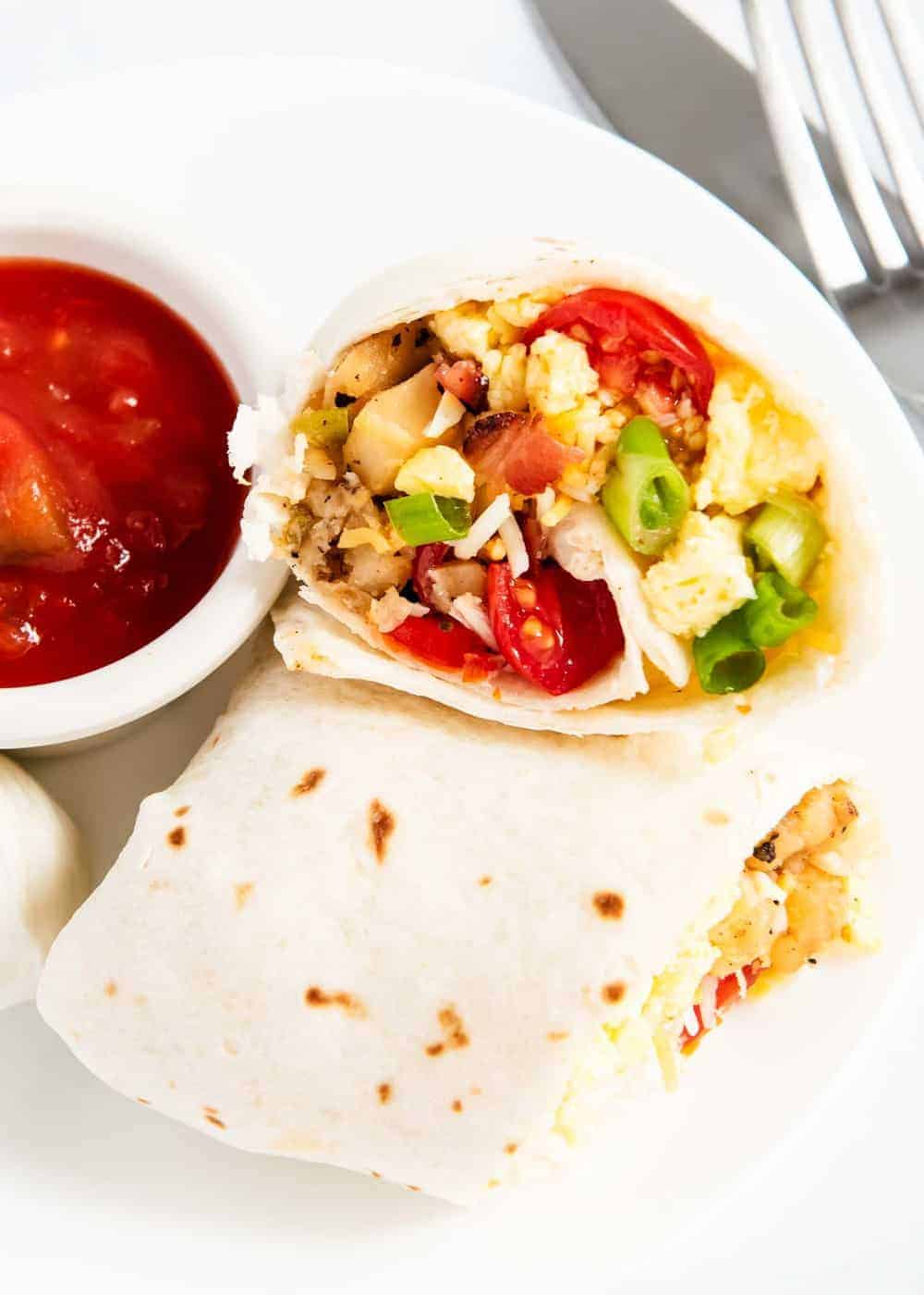 Breakfast burrito on a white plate. 