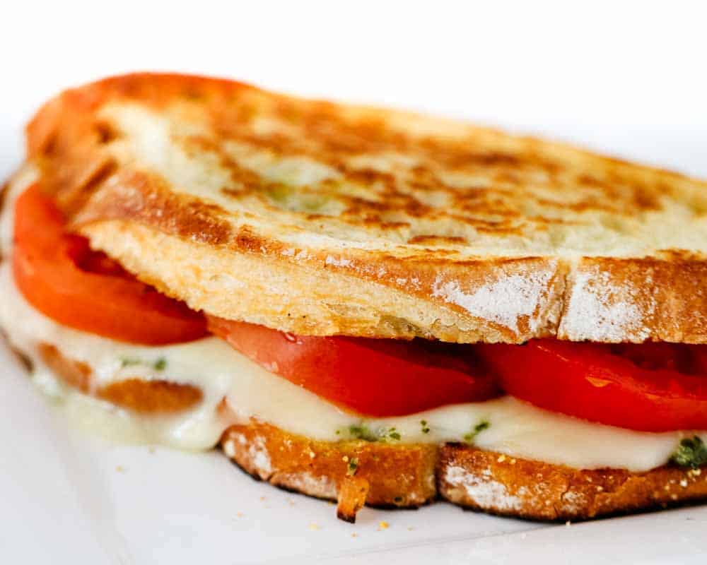 Close up of a grilled caprese sandwich.