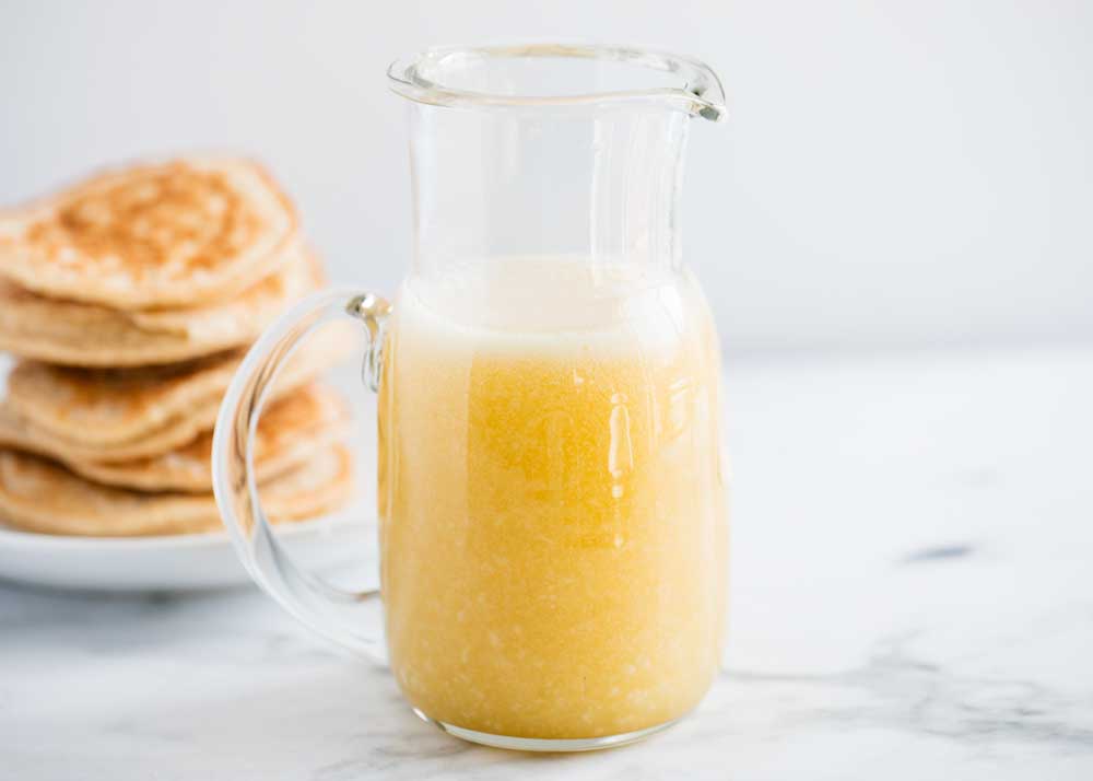 Caramel syrup in a glass jar. 