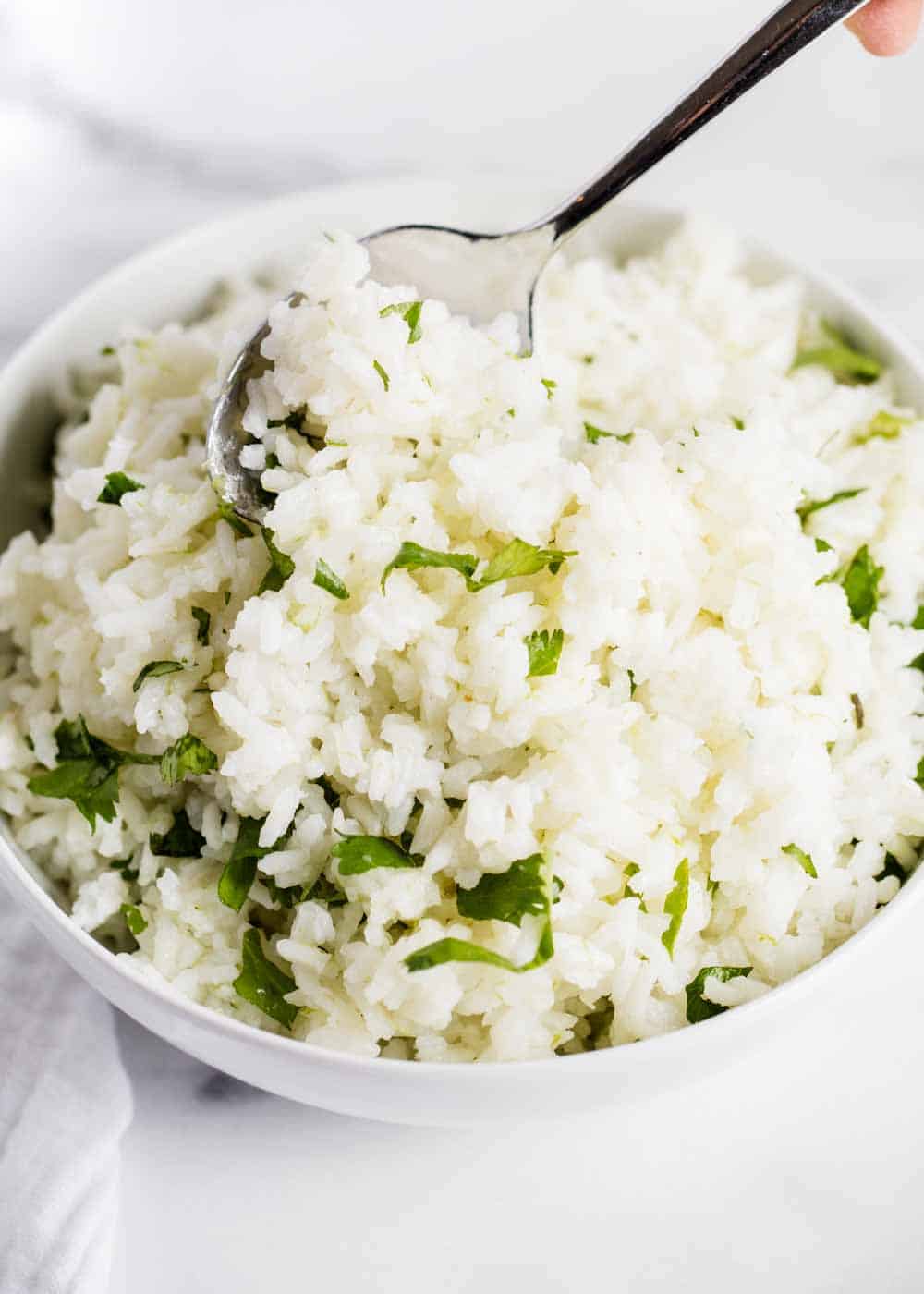 Bowl of cilantro lime rice with spoon.