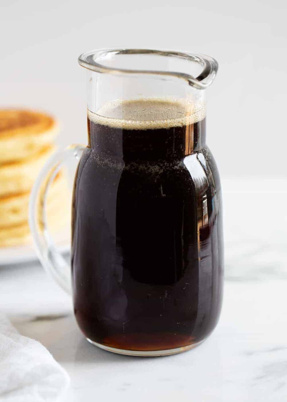 Homemade maple syrup in a glass jar. 