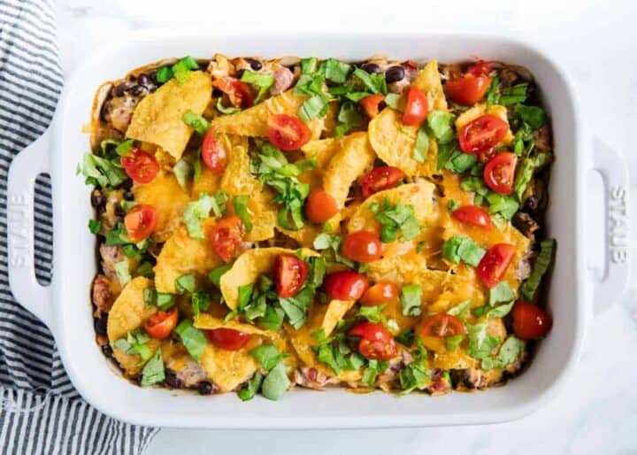 mexican chicken casserole in white baking dish 