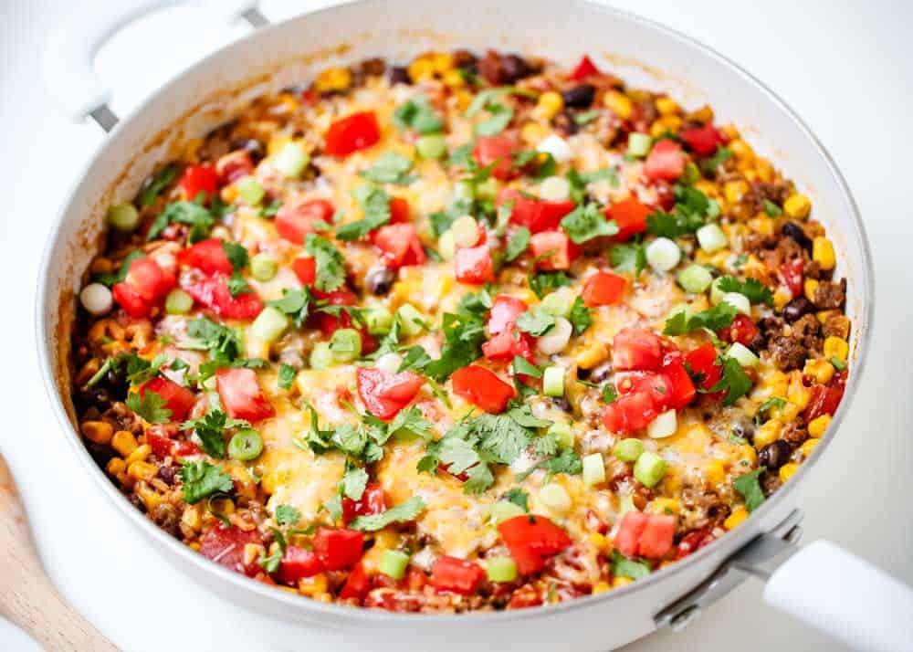Burrito bowl with toppings in large pan.