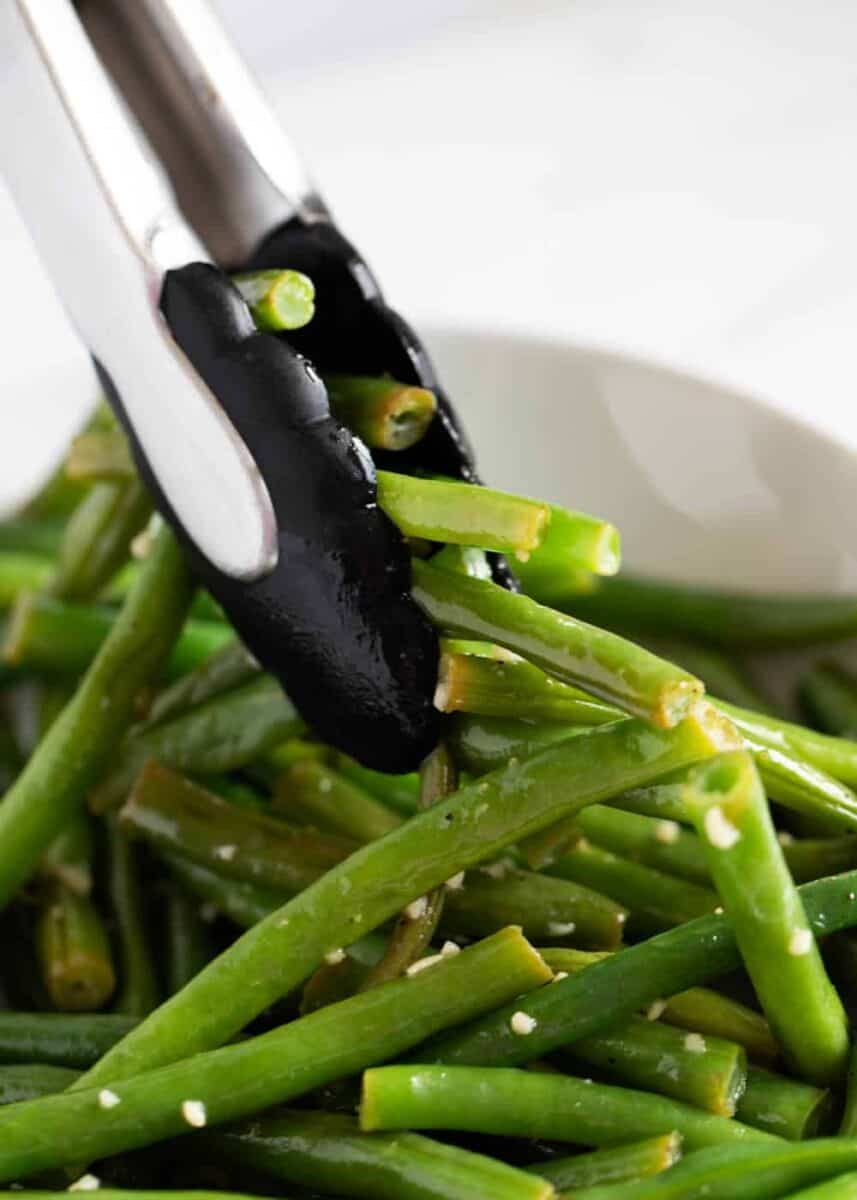 tongs with green beans 