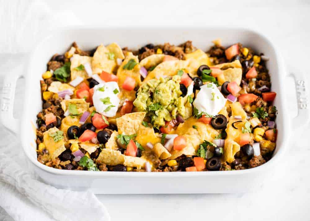 Taco casserole in a white baking dish. 