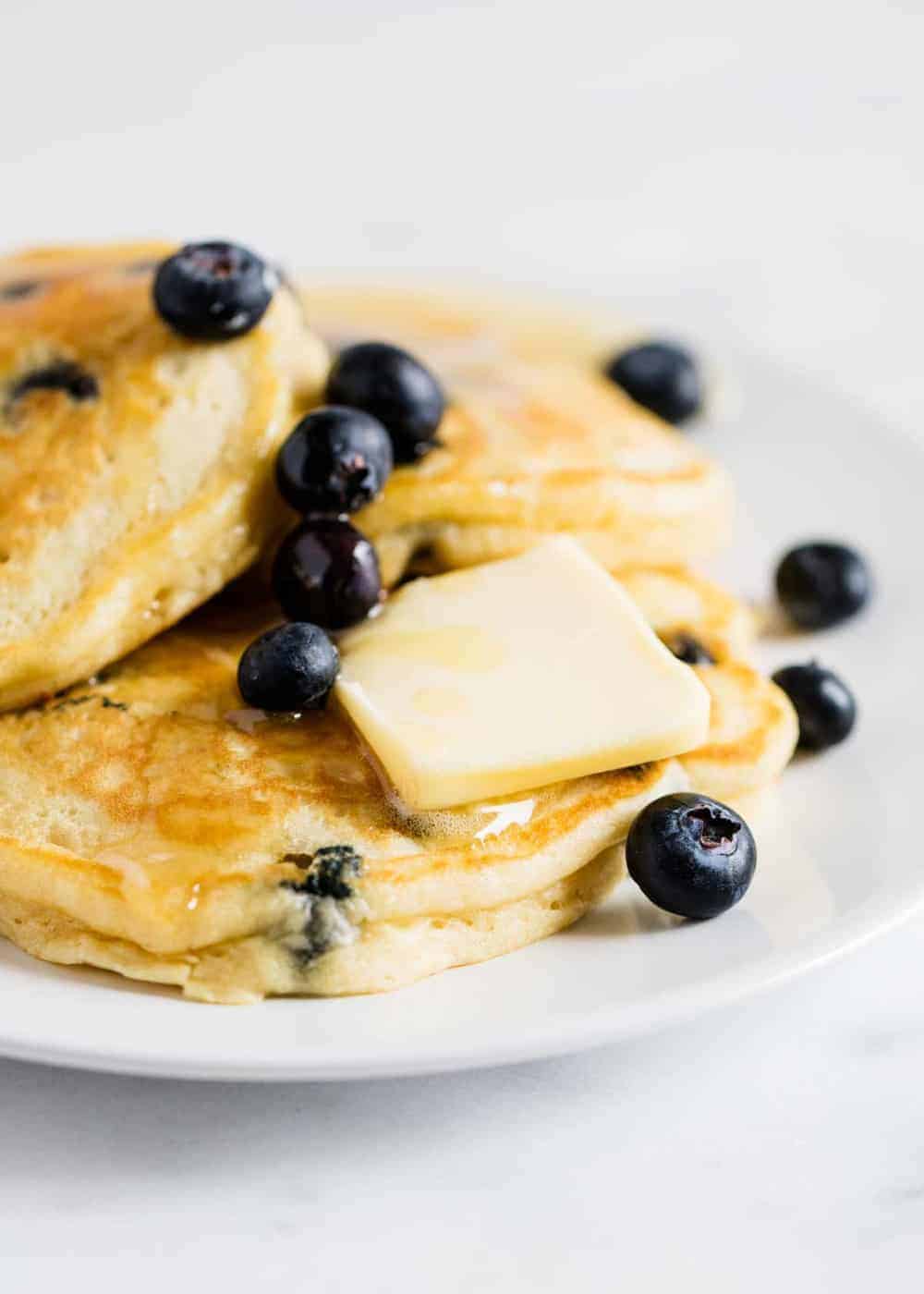 Blueberry pancakes with slab of butter.