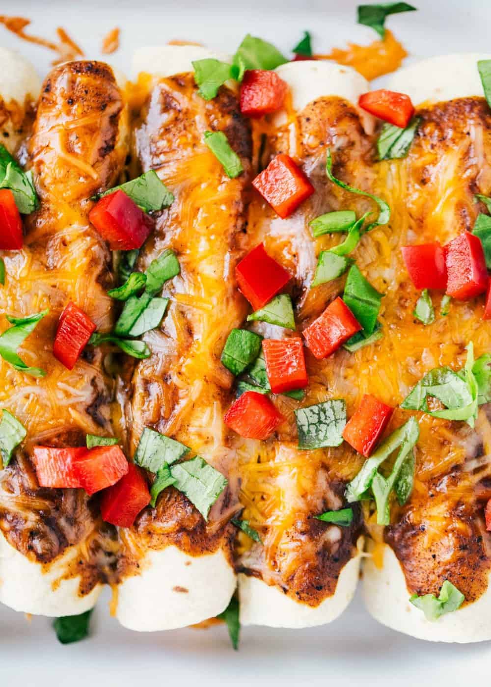 Chicken enchiladas in a baking pan.