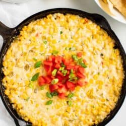 corn dip baked in skillet with tortilla chips