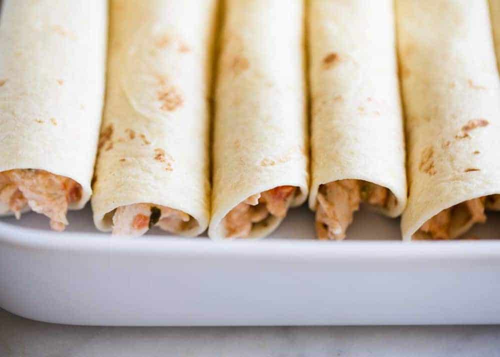 Chicken enchiladas in a baking pan. 