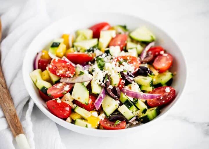 greek salad in a white bowl 