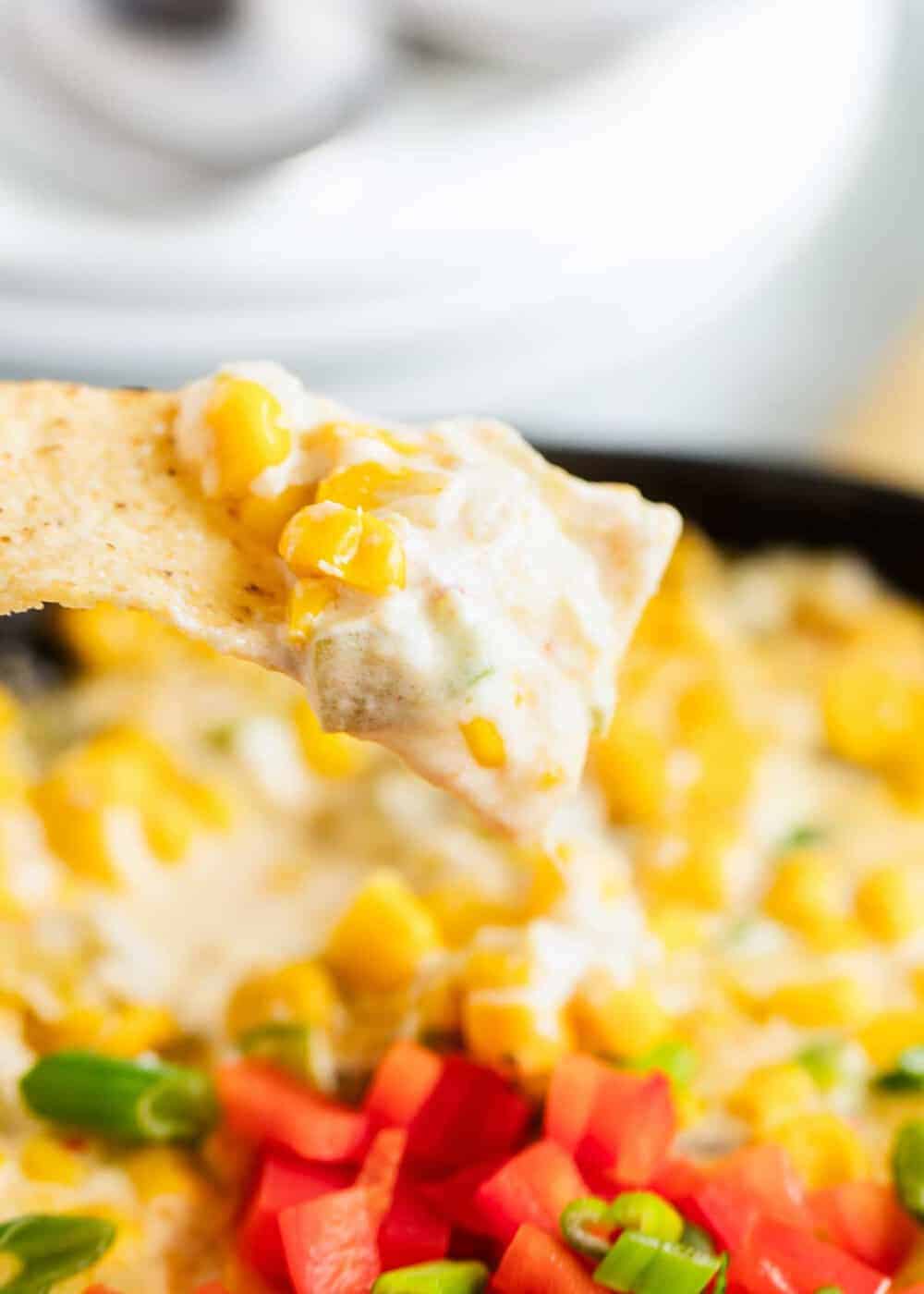 Mexican corn dip on tortilla chip.