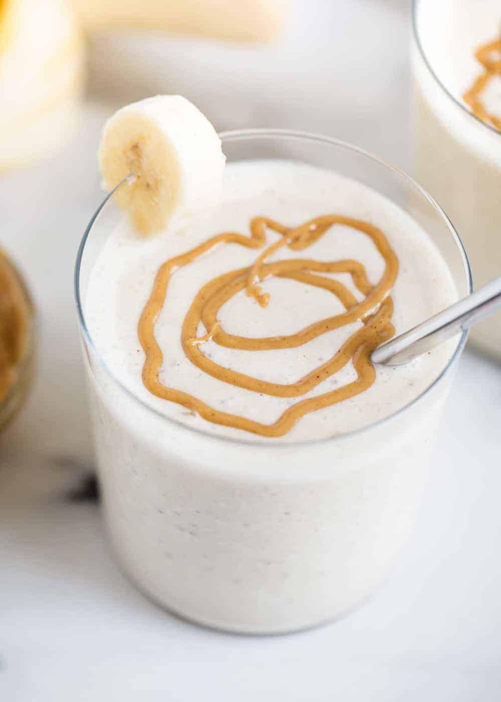 Peanut butter banana smoothie with a peanut butter drizzle on top.