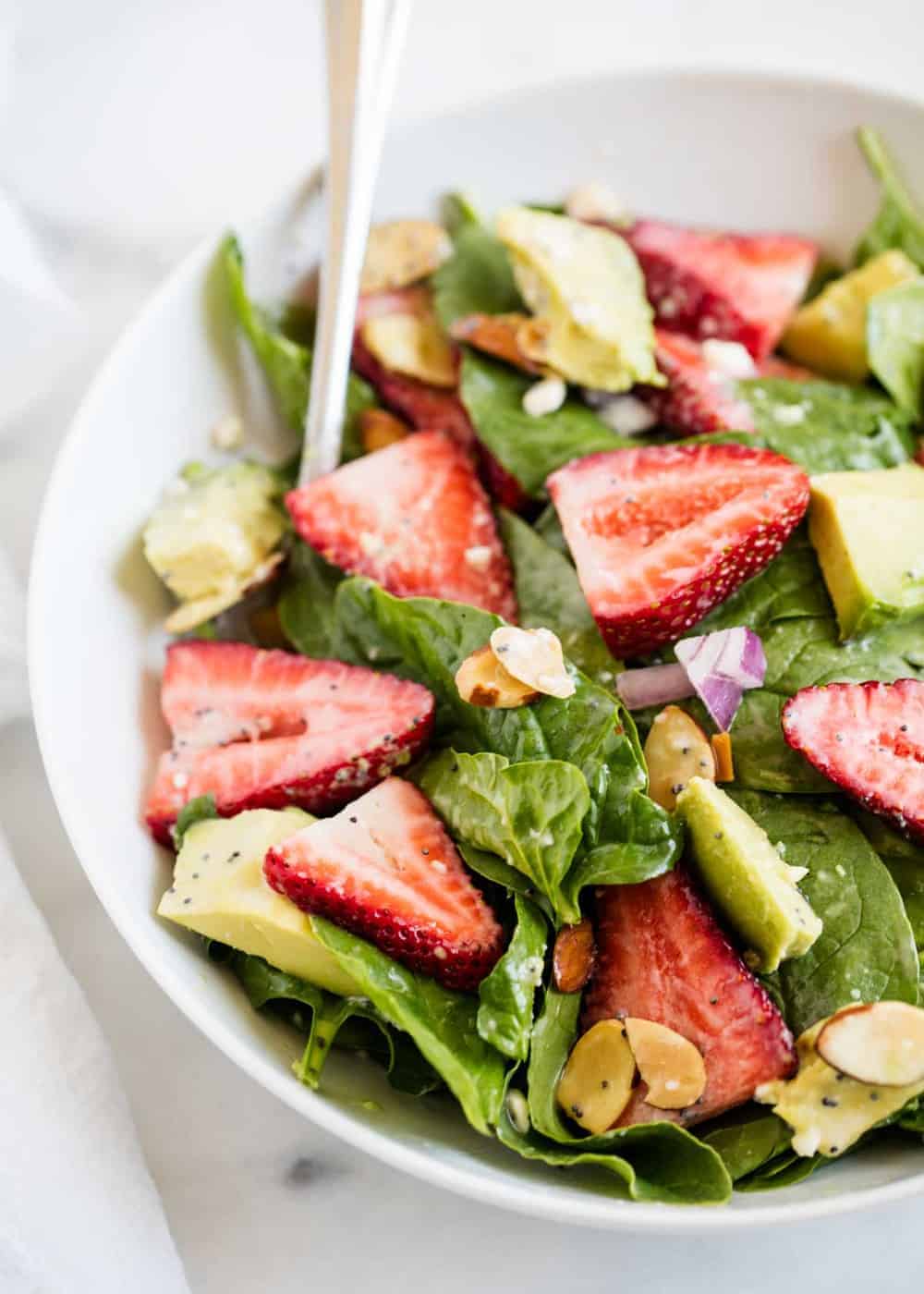 Spinach strawberry salad in bowl.
