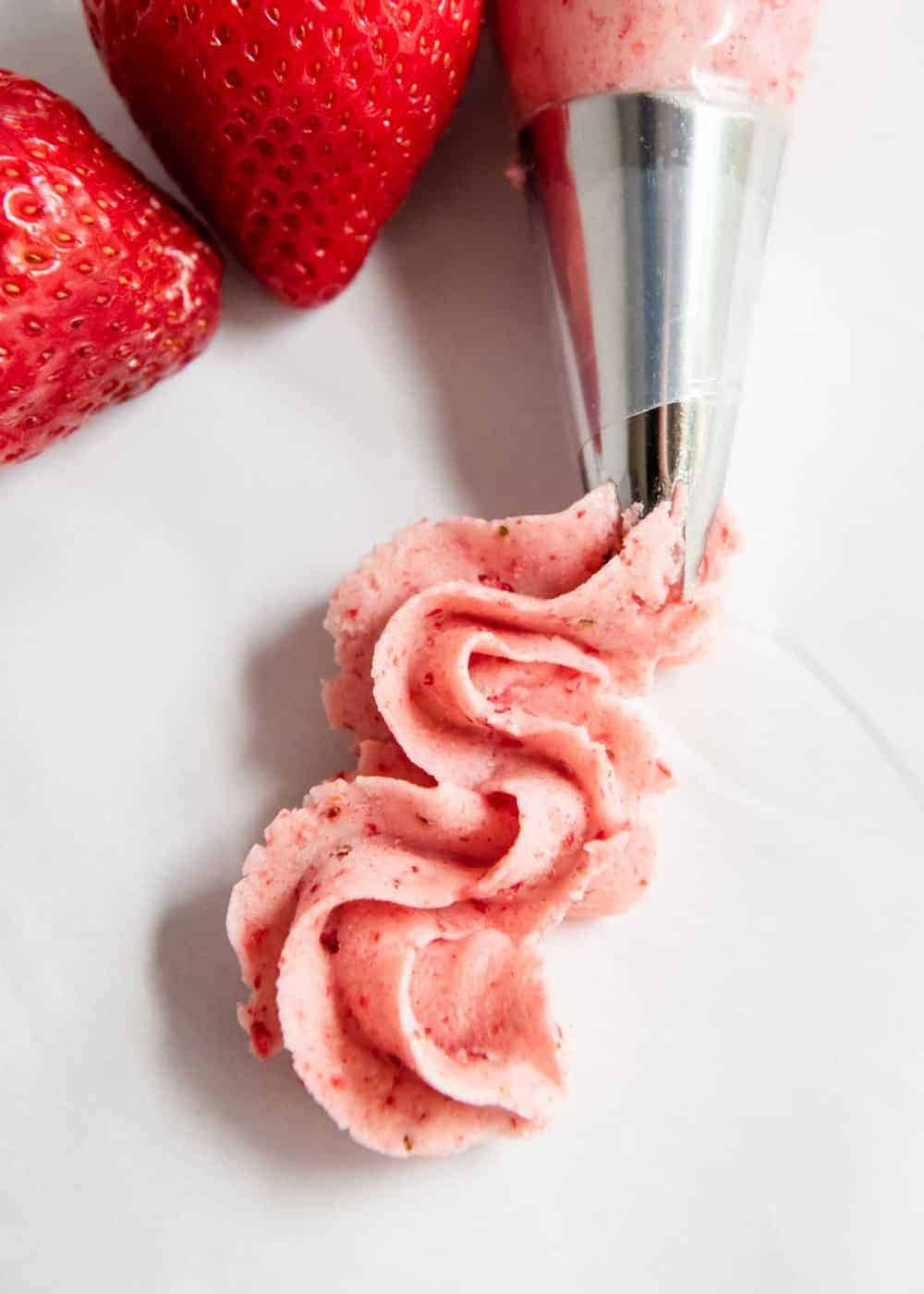 Strawberry buttercream in a piping bag. 