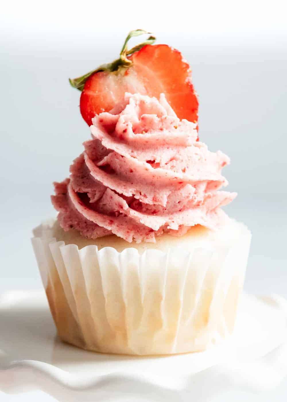 Strawberry frosting on a cupcake. 