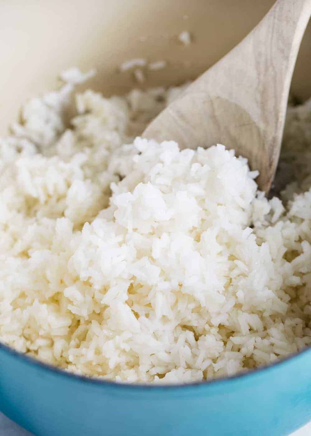 white rice with a wooden spoon 