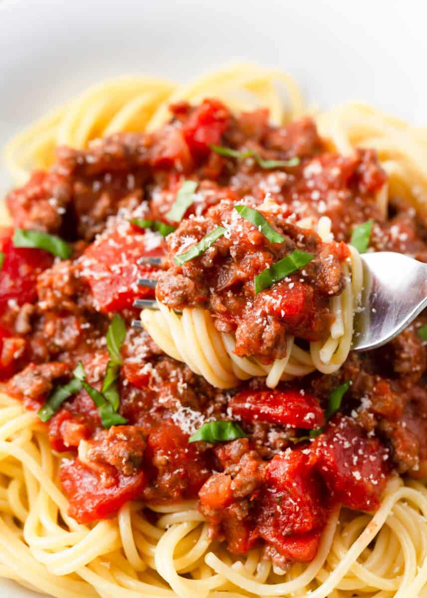 Spaghetti twirled in a fork. 