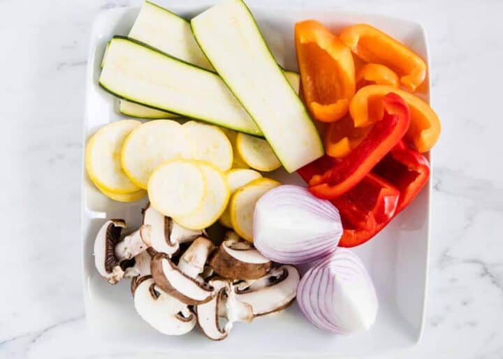 raw sliced vegetables on white plate