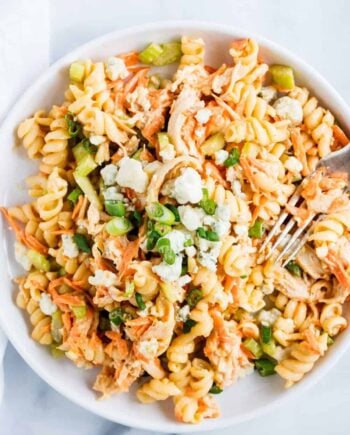 buffalo chicken pasta salad on a white plate with fork