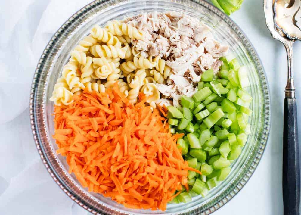 Buffalo pasta salad ingredients in a glass bowl.