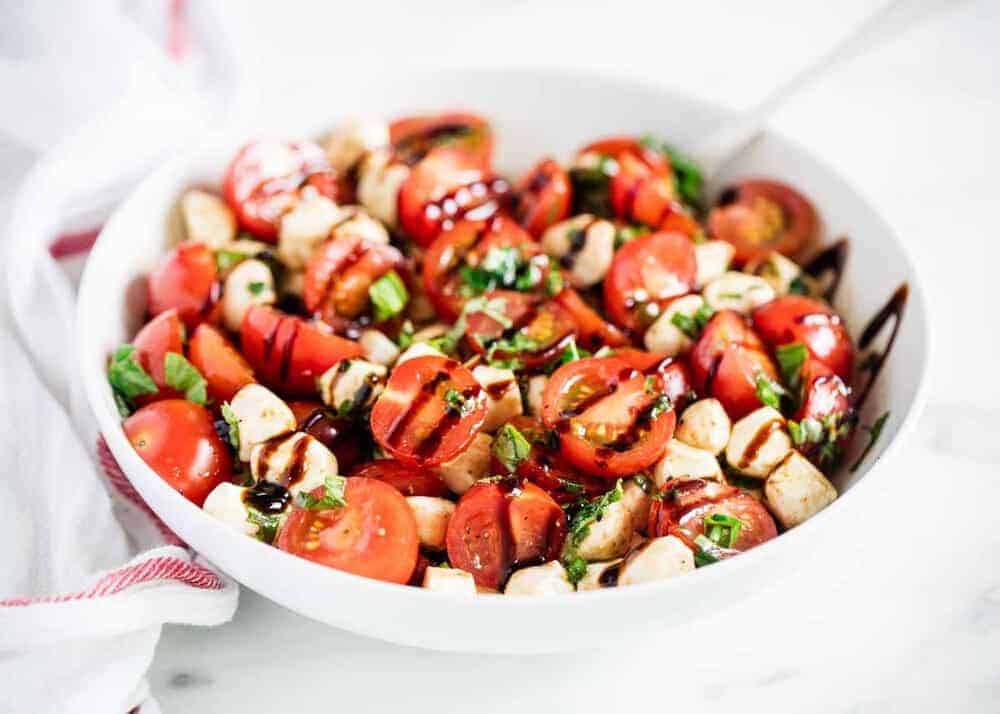 Caprese salad in a white bowl.