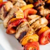 cooked chicken kabobs on white plate