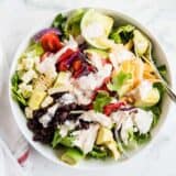 chicken taco salad with salsa ranch dressing in a white bowl