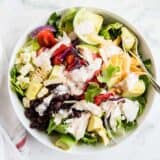 chicken taco salad with salsa ranch dressing in a white bowl