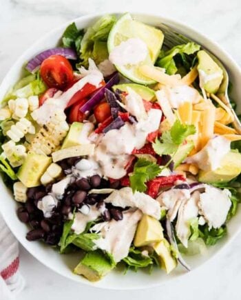 chicken taco salad with salsa ranch dressing in a white bowl