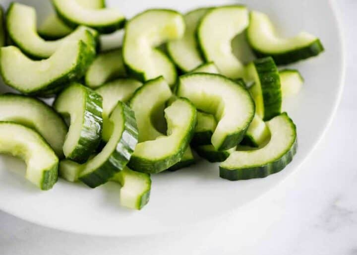 sliced cucumbers on a white plate