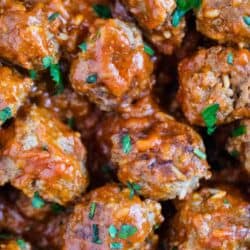 porcupine meatballs in pan with tomato sauce and parsley