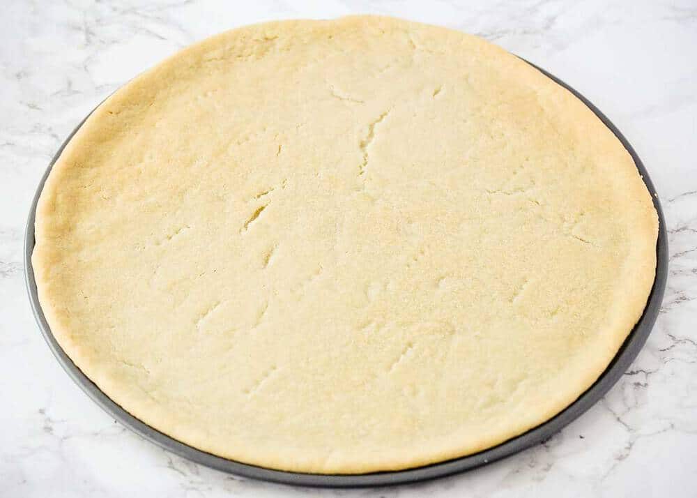 Sugar cookie crust in a pizza pan.