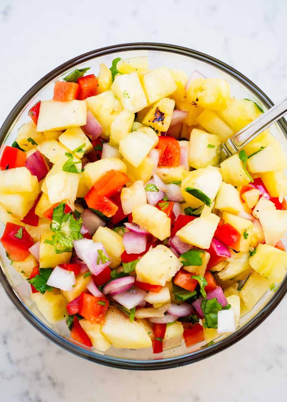 Pineapple salsa in a glass bowl.